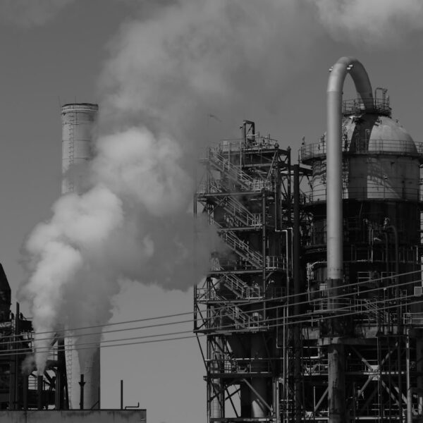 Industrial smokestacks emitting white smoke